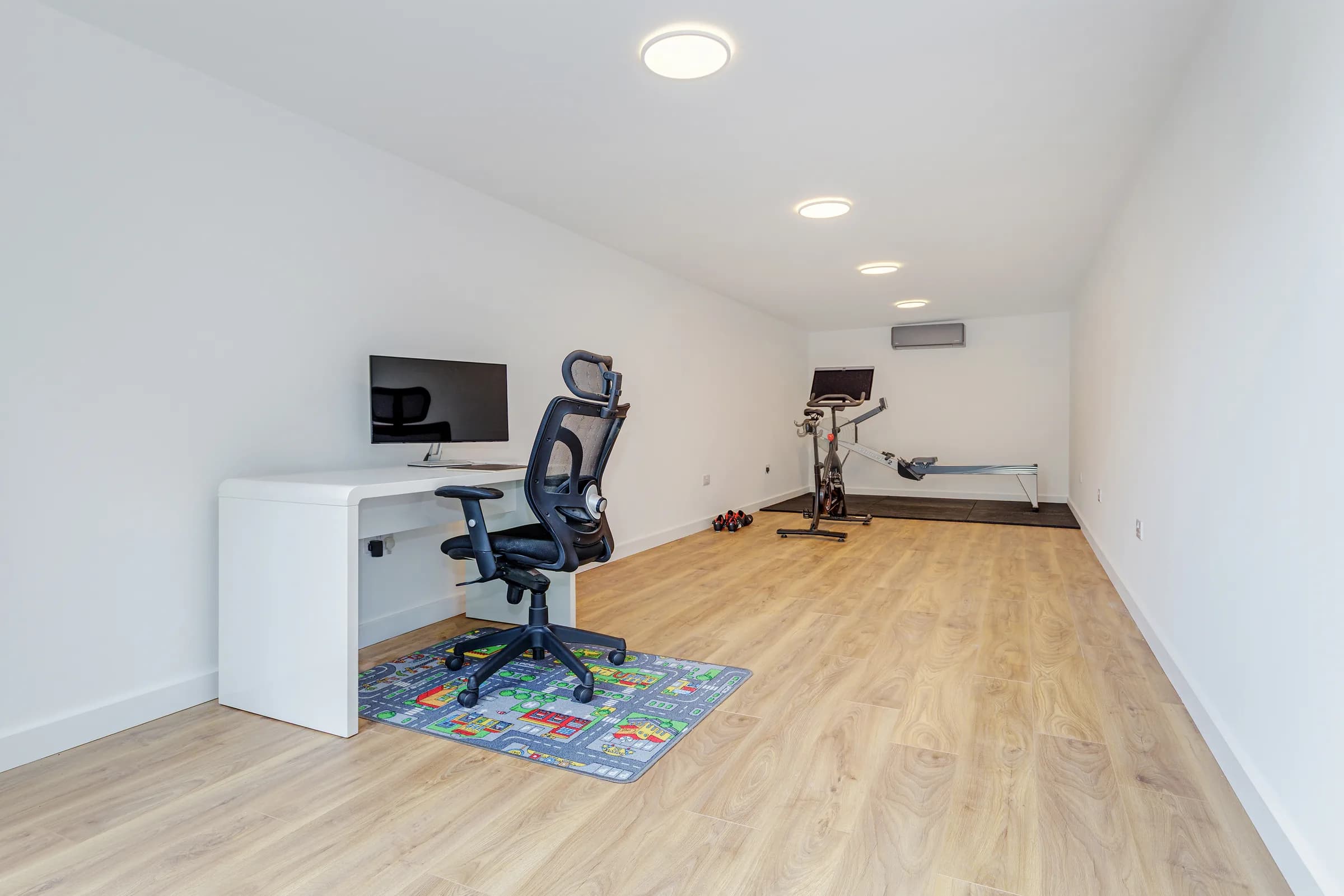Garden studio interior with desk, office chair and exercise equipment
